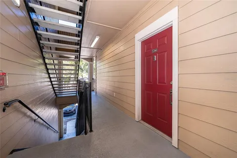 an empty room with a window and wooden floor