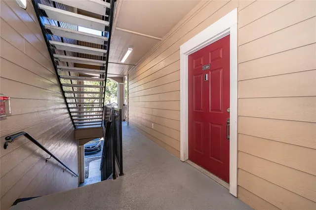 an empty room with a window and wooden floor