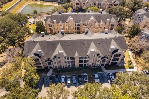 an aerial view of house with yard and swimming pool