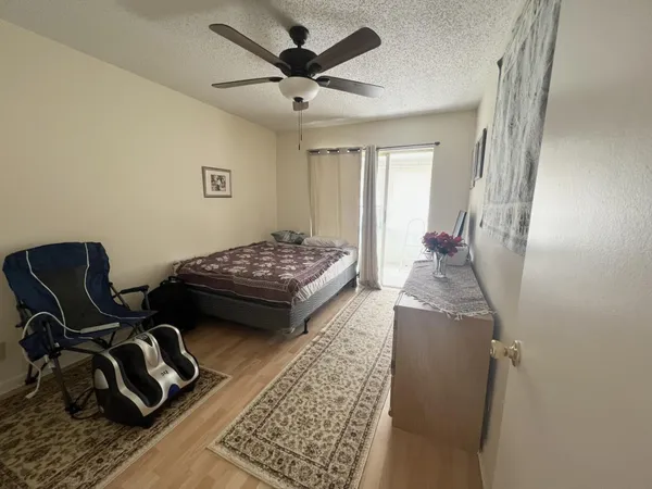 a bedroom with furniture and a rug