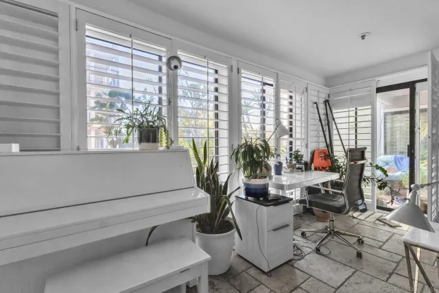 a living room with furniture and floor to ceiling windows