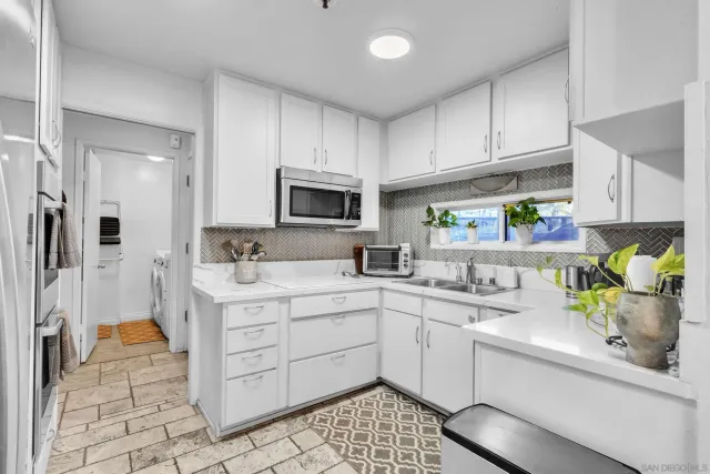 a kitchen with a sink stainless steel appliances and cabinets