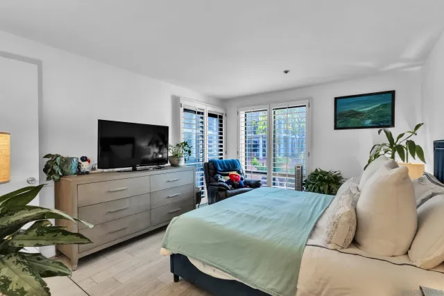 a bedroom with furniture and a flat screen tv