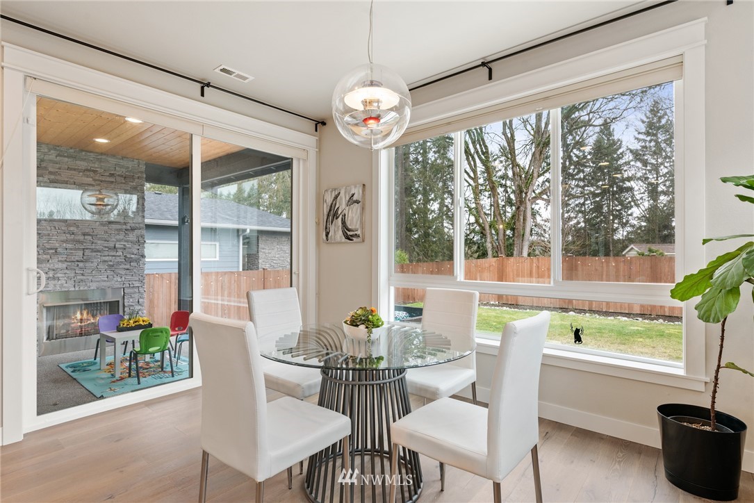 23417 26th Avenue Southeast Bothell, WA 98021 - Photo 14 of 40 a dining room with furniture a chandelier and glass door