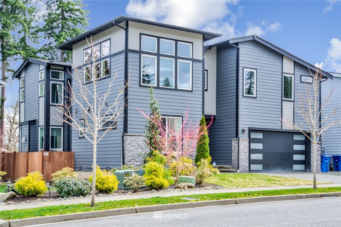 23417 26th Avenue Southeast Bothell, WA 98021 - Photo 2 of 40 a front view of a house with a yard and garage