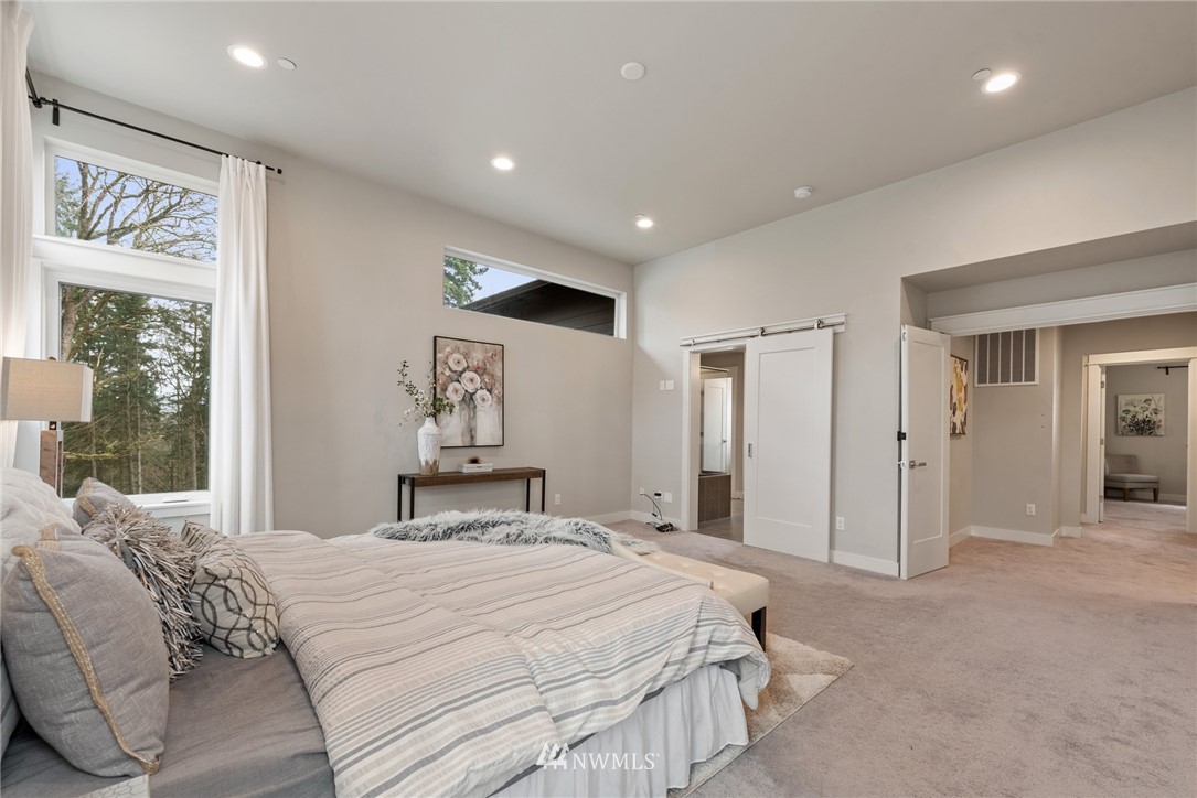 23417 26th Avenue Southeast Bothell, WA 98021 - Photo 26 of 40 a bedroom with a large bed and a large mirror