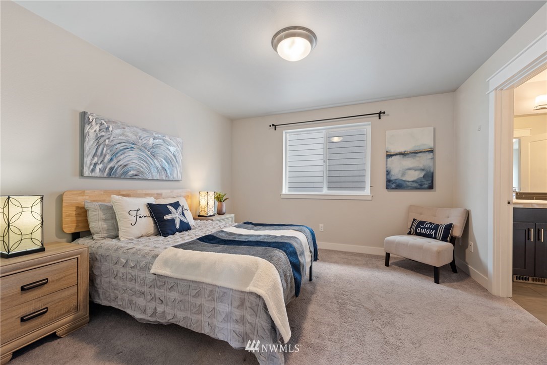 23417 26th Avenue Southeast Bothell, WA 98021 - Photo 31 of 40 a spacious bedroom with a bed and a couch