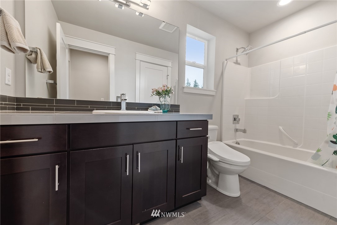 23417 26th Avenue Southeast Bothell, WA 98021 - Photo 34 of 40 a bathroom with a sink toilet a mirror and shower