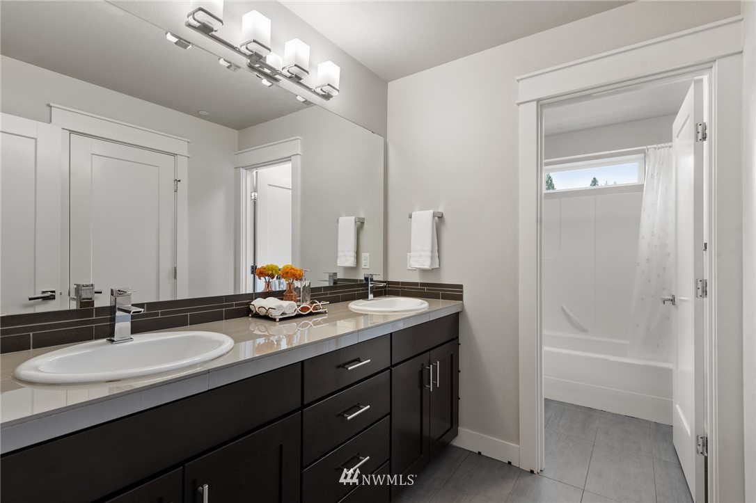 23417 26th Avenue Southeast Bothell, WA 98021 - Photo 35 of 40 a bathroom with double vanity sinks a vanity and a mirror