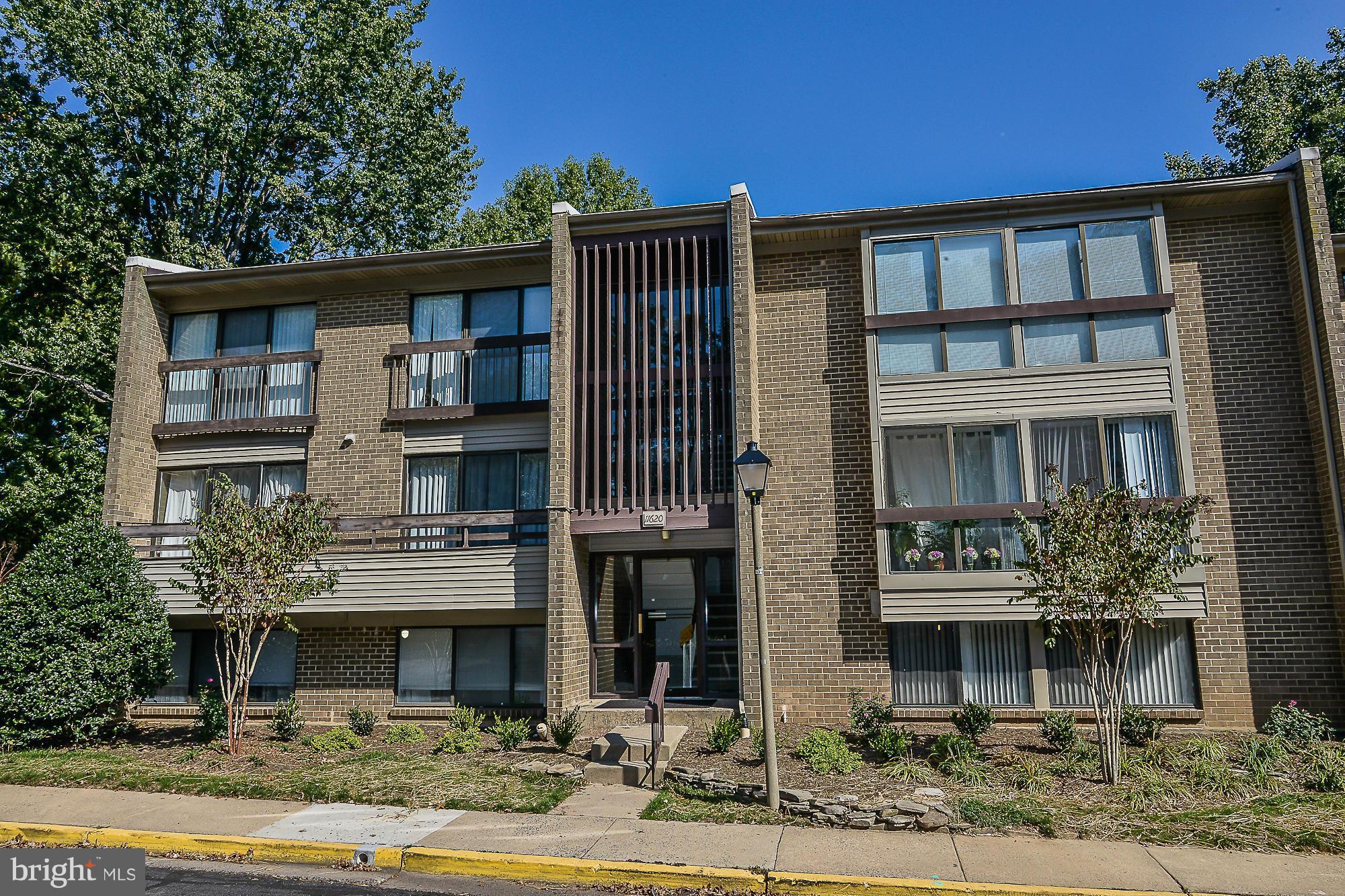 11620 Ivystone Court, Unit 101 Reston, VA 20191 - Photo 2 of 20 a front view of a house with garden