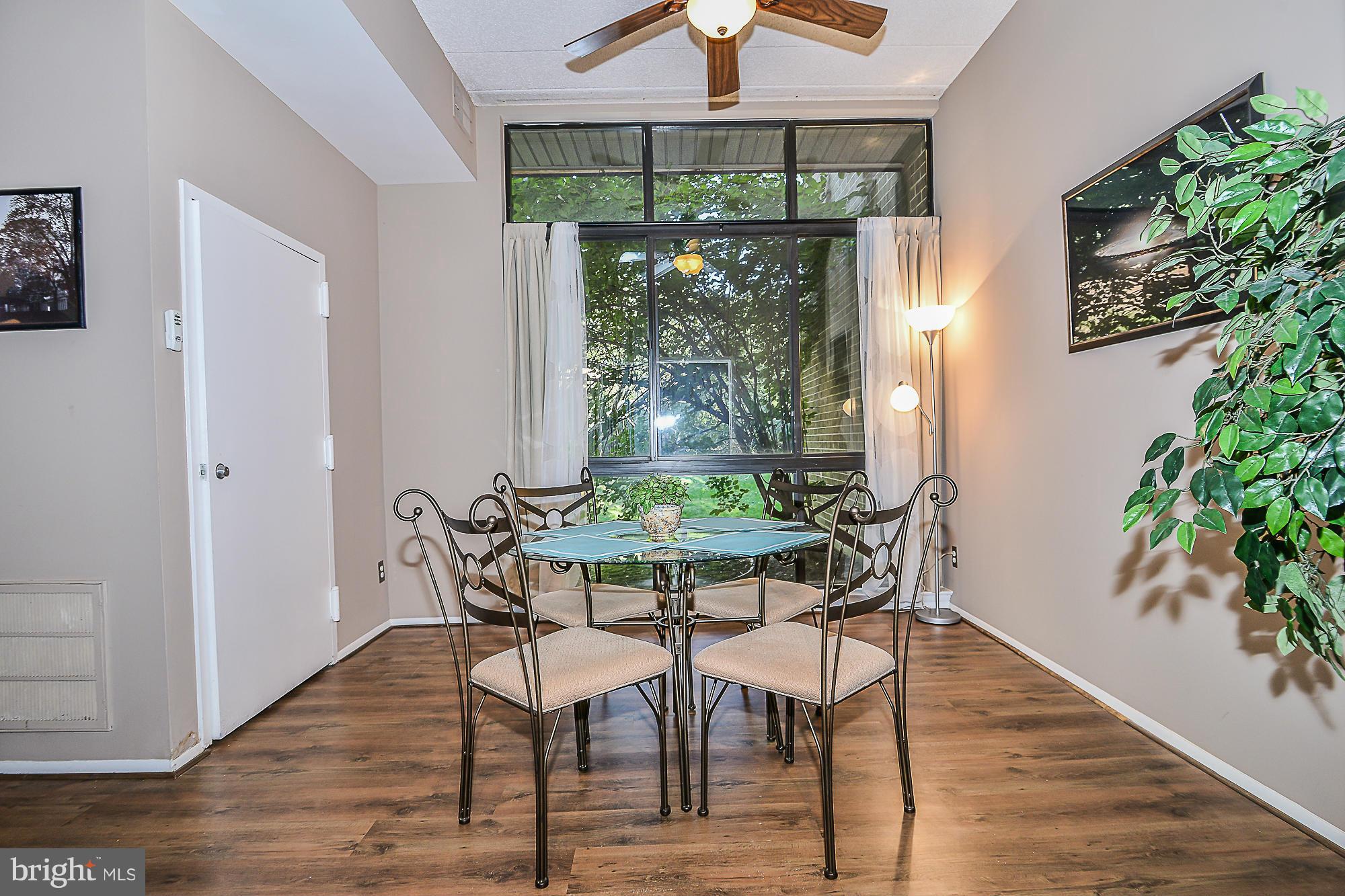 11620 Ivystone Court, Unit 101 Reston, VA 20191 - Photo 12 of 20 a dining room with furniture window and wooden floor