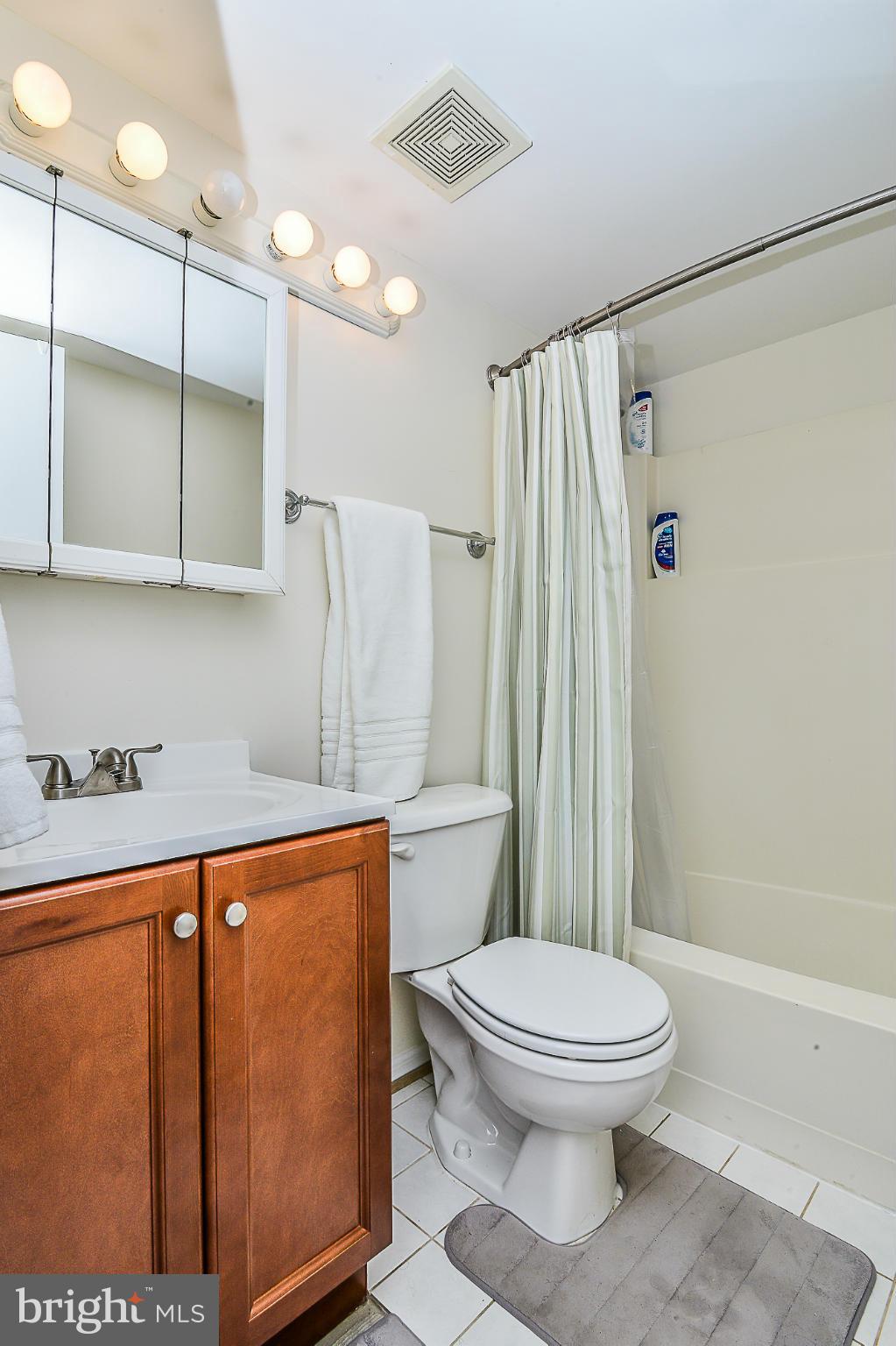 11620 Ivystone Court, Unit 101 Reston, VA 20191 - Photo 15 of 20 a white toilet sitting next to a bathroom sink
