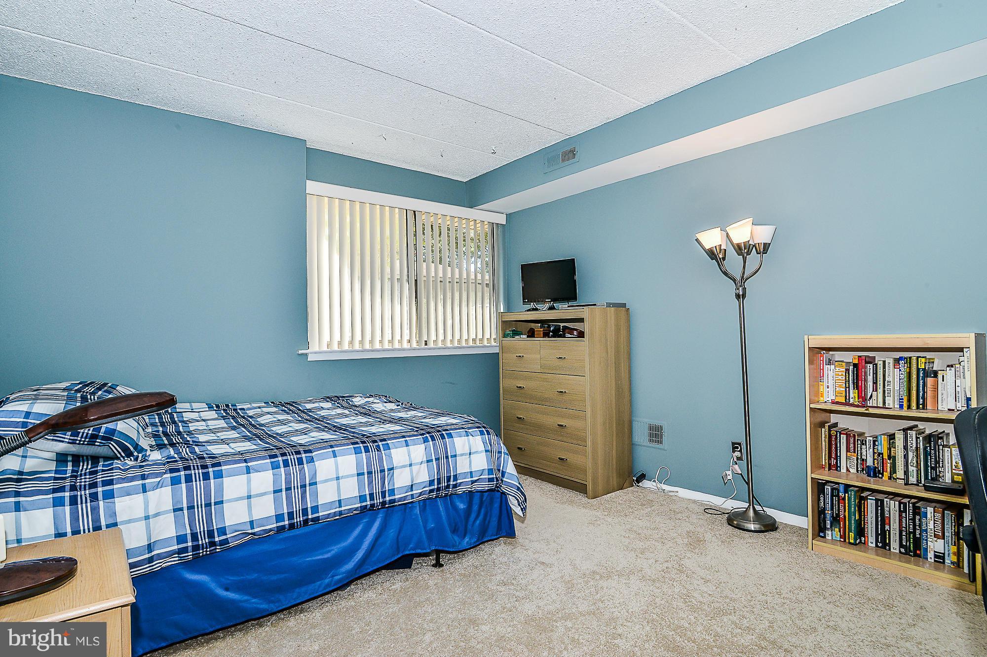 11620 Ivystone Court, Unit 101 Reston, VA 20191 - Photo 17 of 20 a bedroom with a bed and a bookshelf