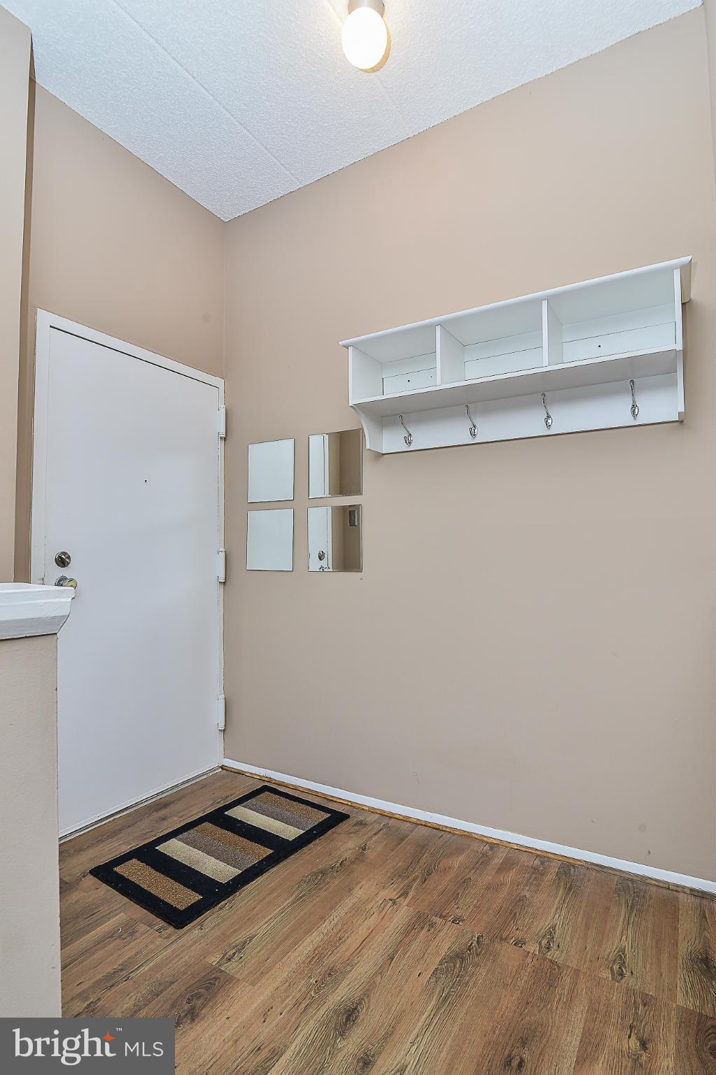 11620 Ivystone Court, Unit 101 Reston, VA 20191 - Photo 3 of 20 a view of a livingroom with racks on the wall