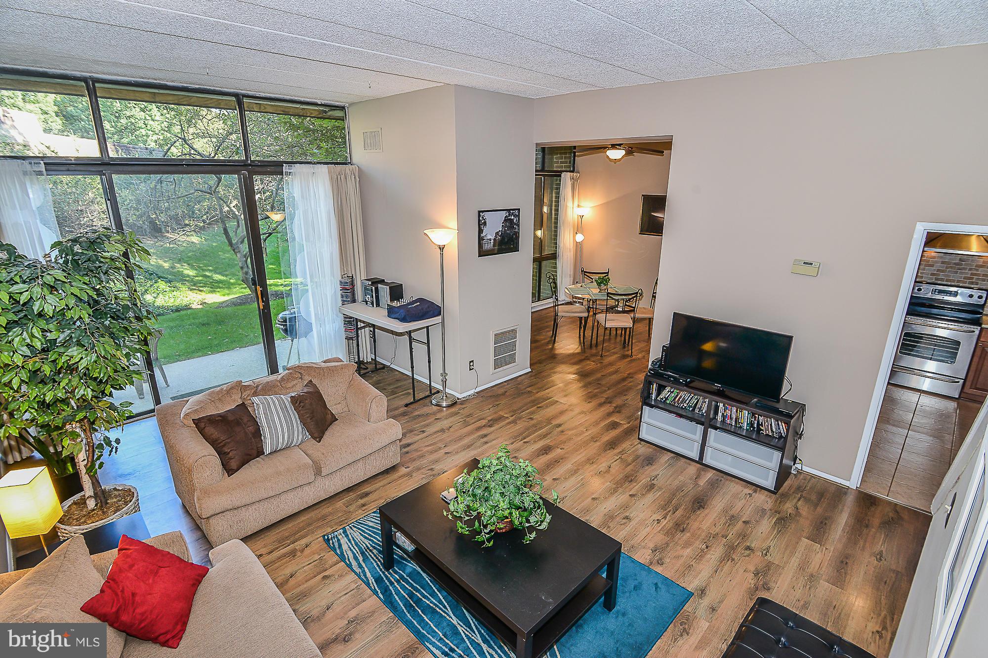 11620 Ivystone Court, Unit 101 Reston, VA 20191 - Photo 4 of 20 a living room with furniture and a window