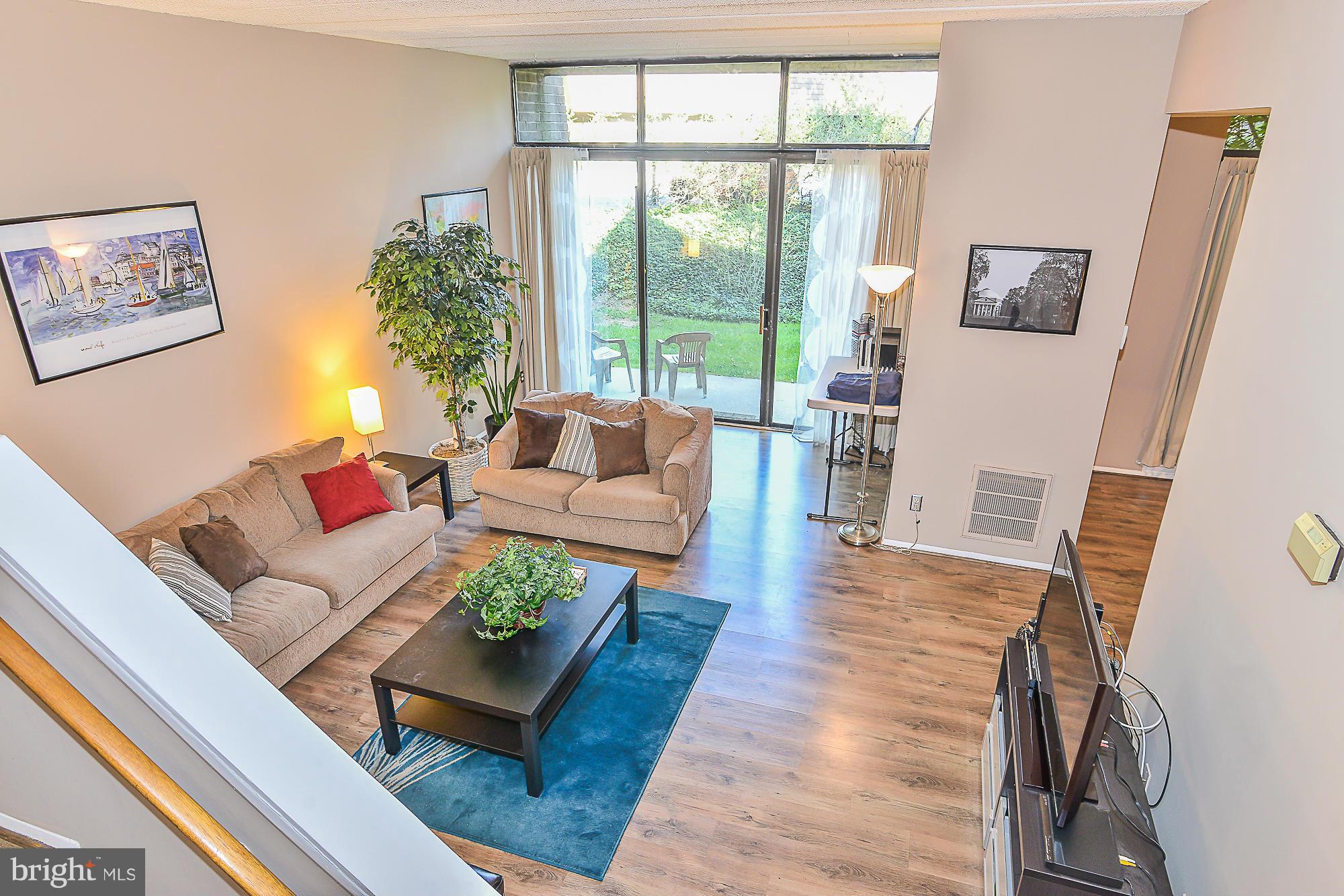 11620 Ivystone Court, Unit 101 Reston, VA 20191 - Photo 5 of 20 a living room with furniture and a large window