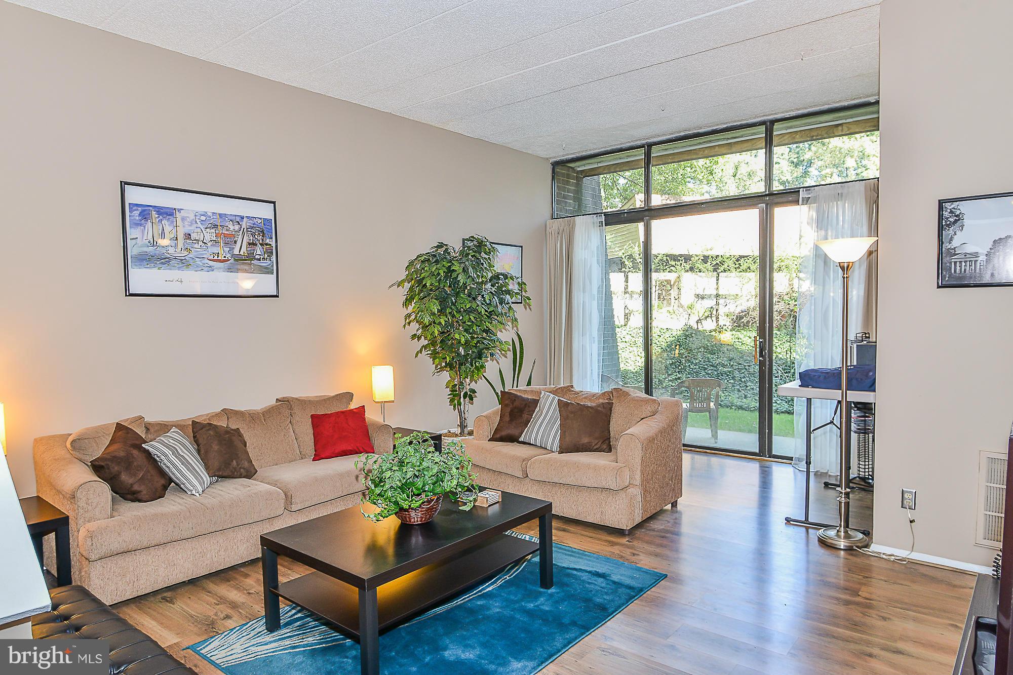11620 Ivystone Court, Unit 101 Reston, VA 20191 - Photo 6 of 20 a living room with furniture and a large window
