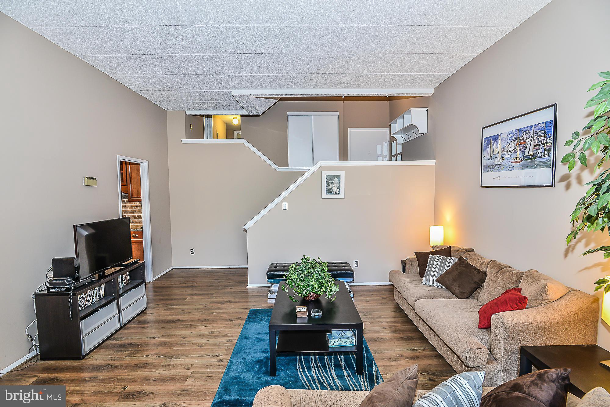 11620 Ivystone Court, Unit 101 Reston, VA 20191 - Photo 8 of 20 a living room with furniture and a flat screen tv