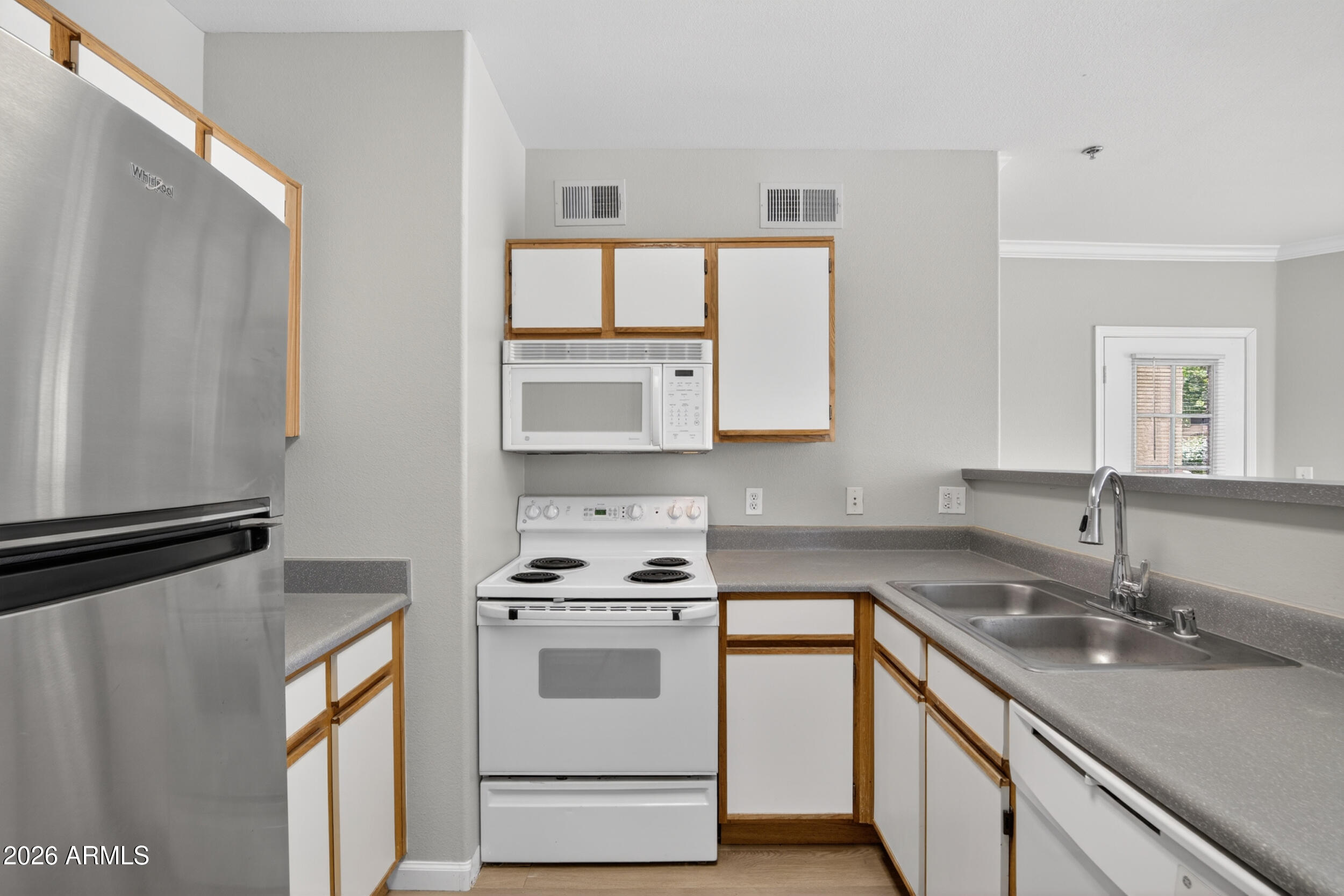 2134 East Broadway Road, Unit 1042 Tempe, AZ 85282 - Photo 11 of 33 a kitchen with appliances cabinets and a sink