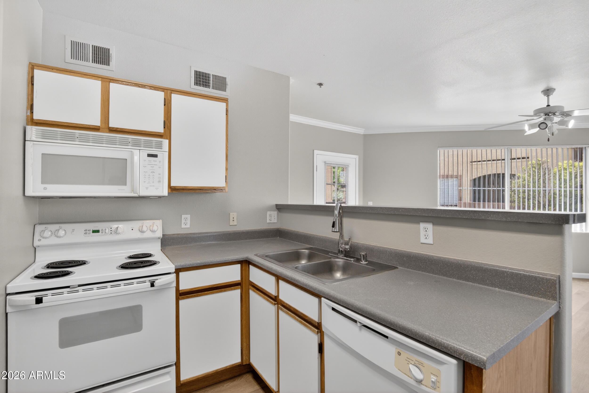 2134 East Broadway Road, Unit 1042 Tempe, AZ 85282 - Photo 12 of 33 a kitchen with appliances cabinets and a sink