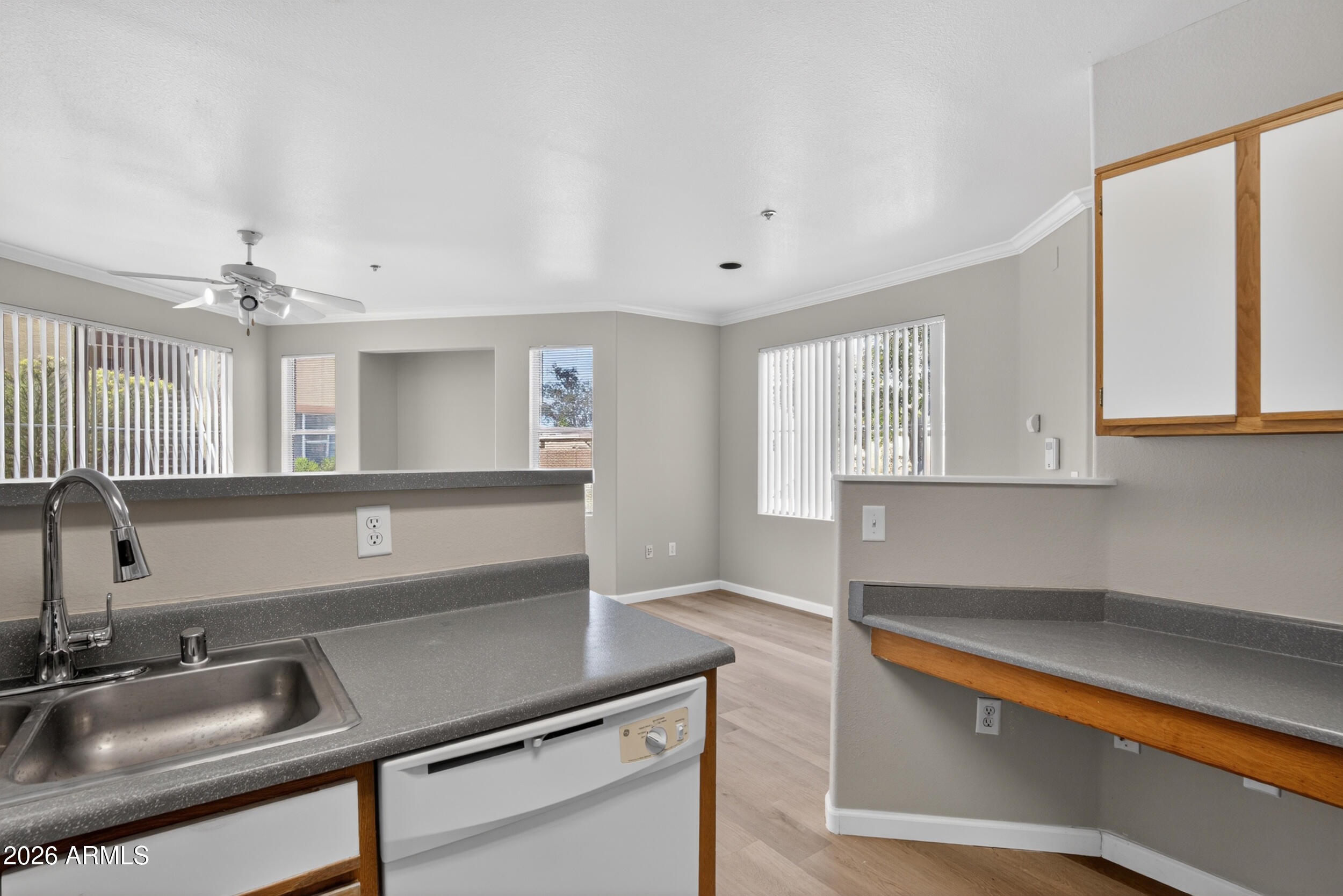 2134 East Broadway Road, Unit 1042 Tempe, AZ 85282 - Photo 13 of 33 a kitchen with granite countertop a sink and white cabinets