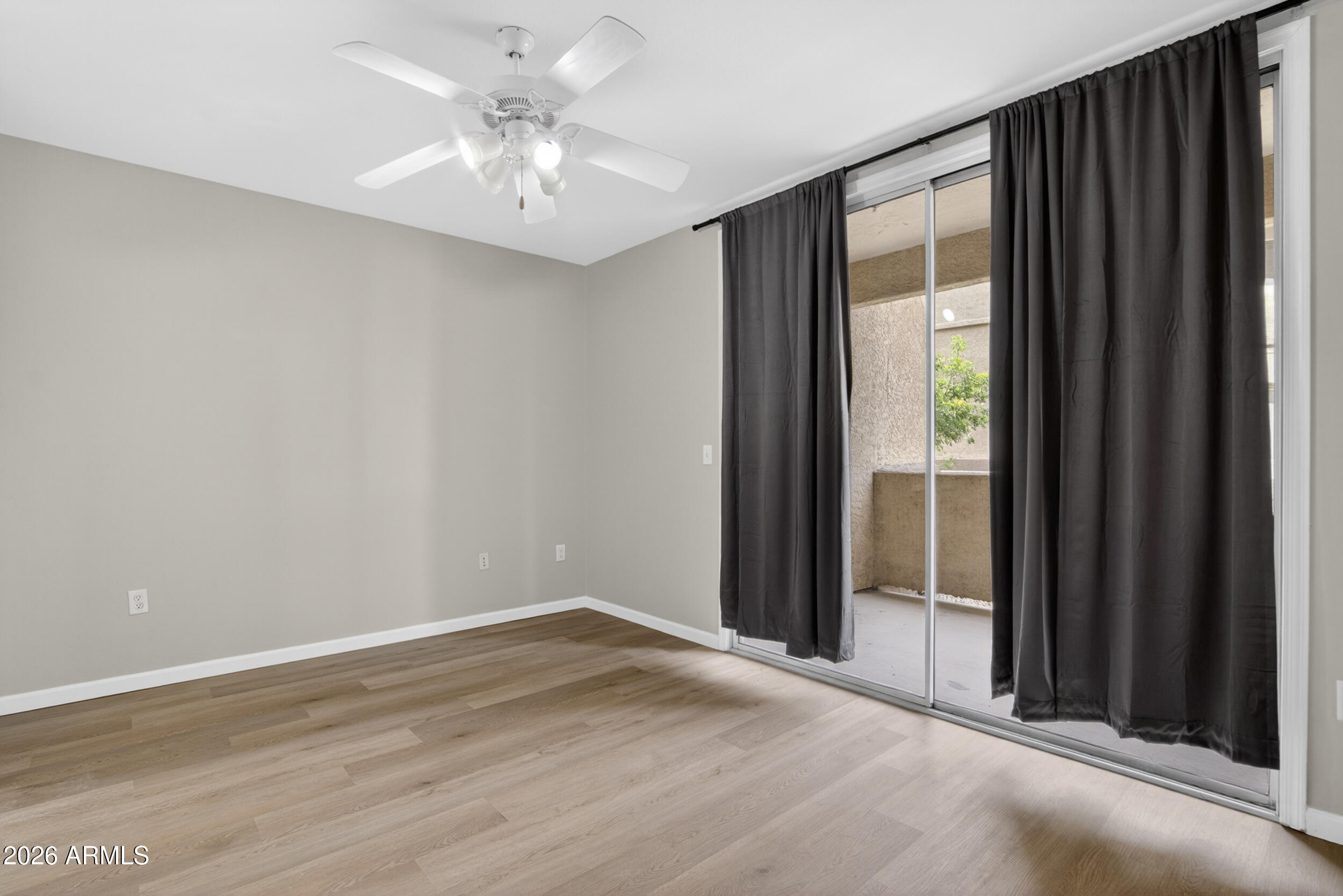 2134 East Broadway Road, Unit 1042 Tempe, AZ 85282 - Photo 14 of 33 an empty room with fan and windows