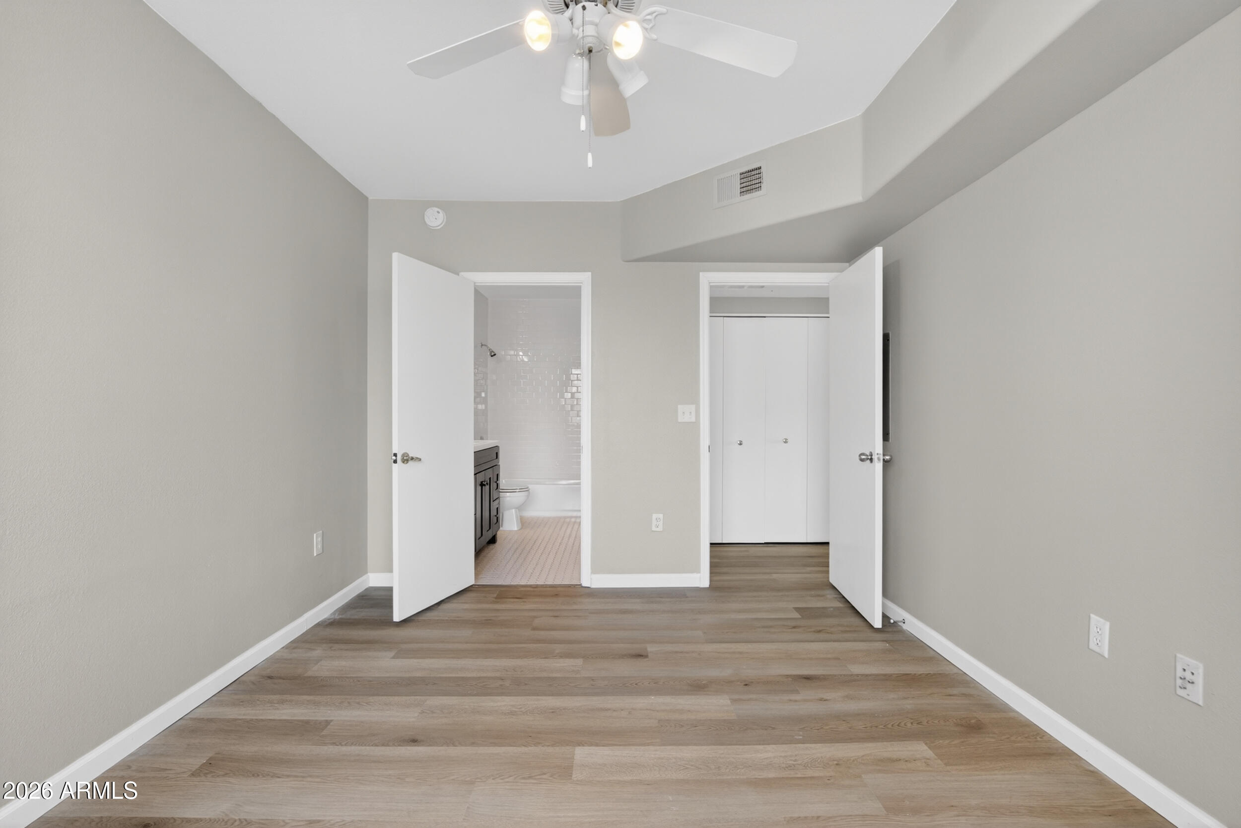 2134 East Broadway Road, Unit 1042 Tempe, AZ 85282 - Photo 17 of 33 a view of an empty room with wooden floor