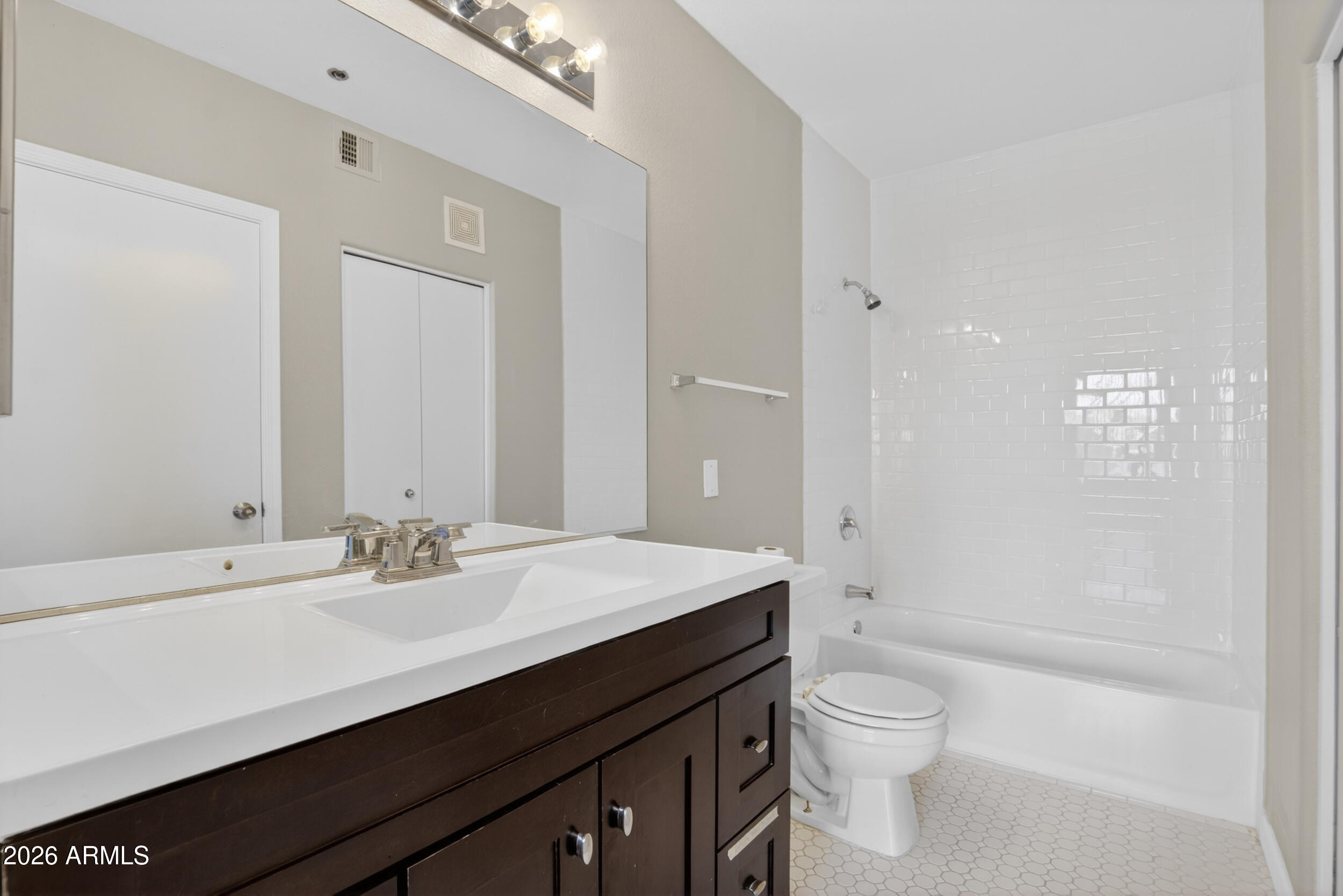 2134 East Broadway Road, Unit 1042 Tempe, AZ 85282 - Photo 18 of 33 a bathroom with a sink a toilet a shower and a mirror