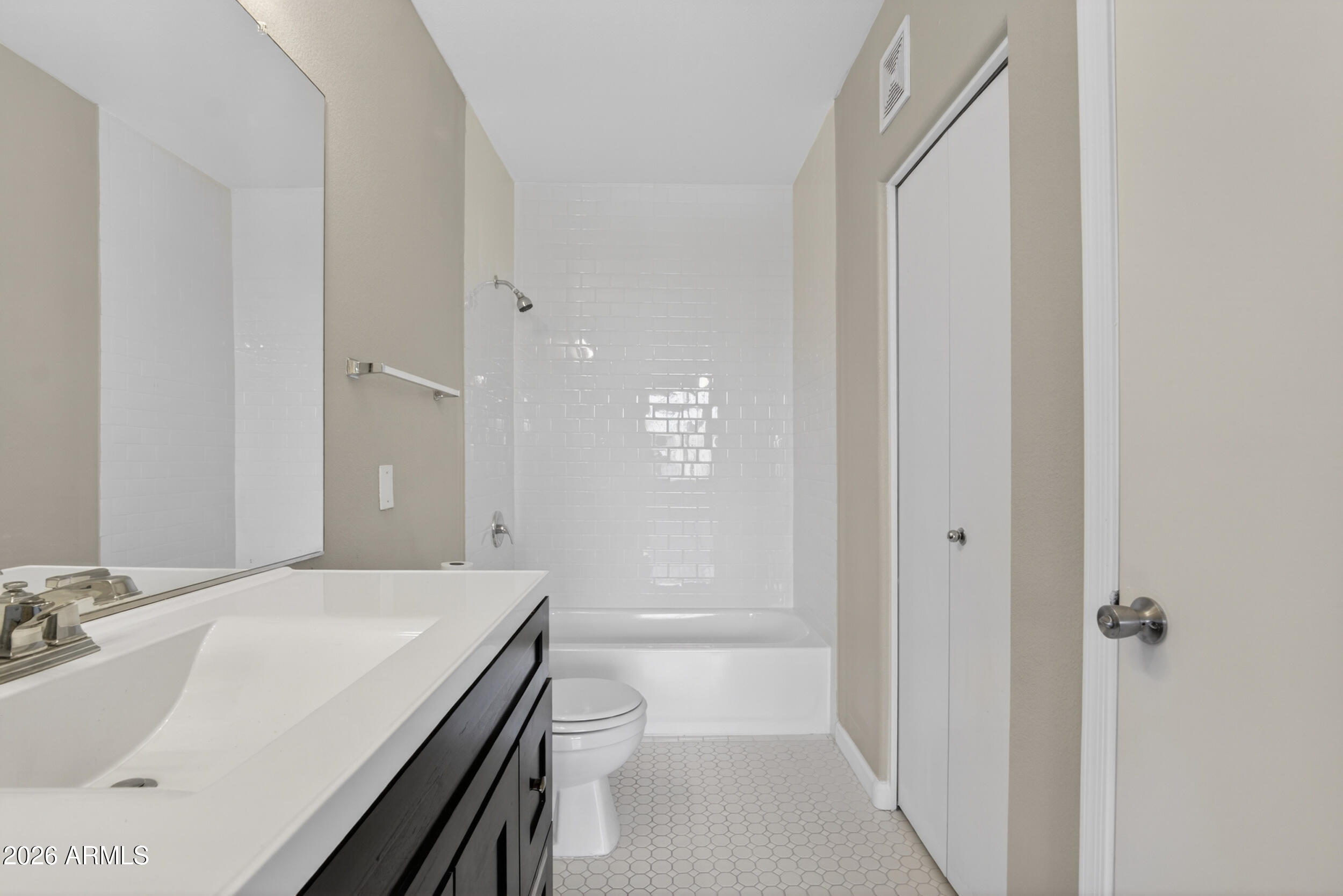2134 East Broadway Road, Unit 1042 Tempe, AZ 85282 - Photo 19 of 33 a bathroom with a sink and mirror with toilet