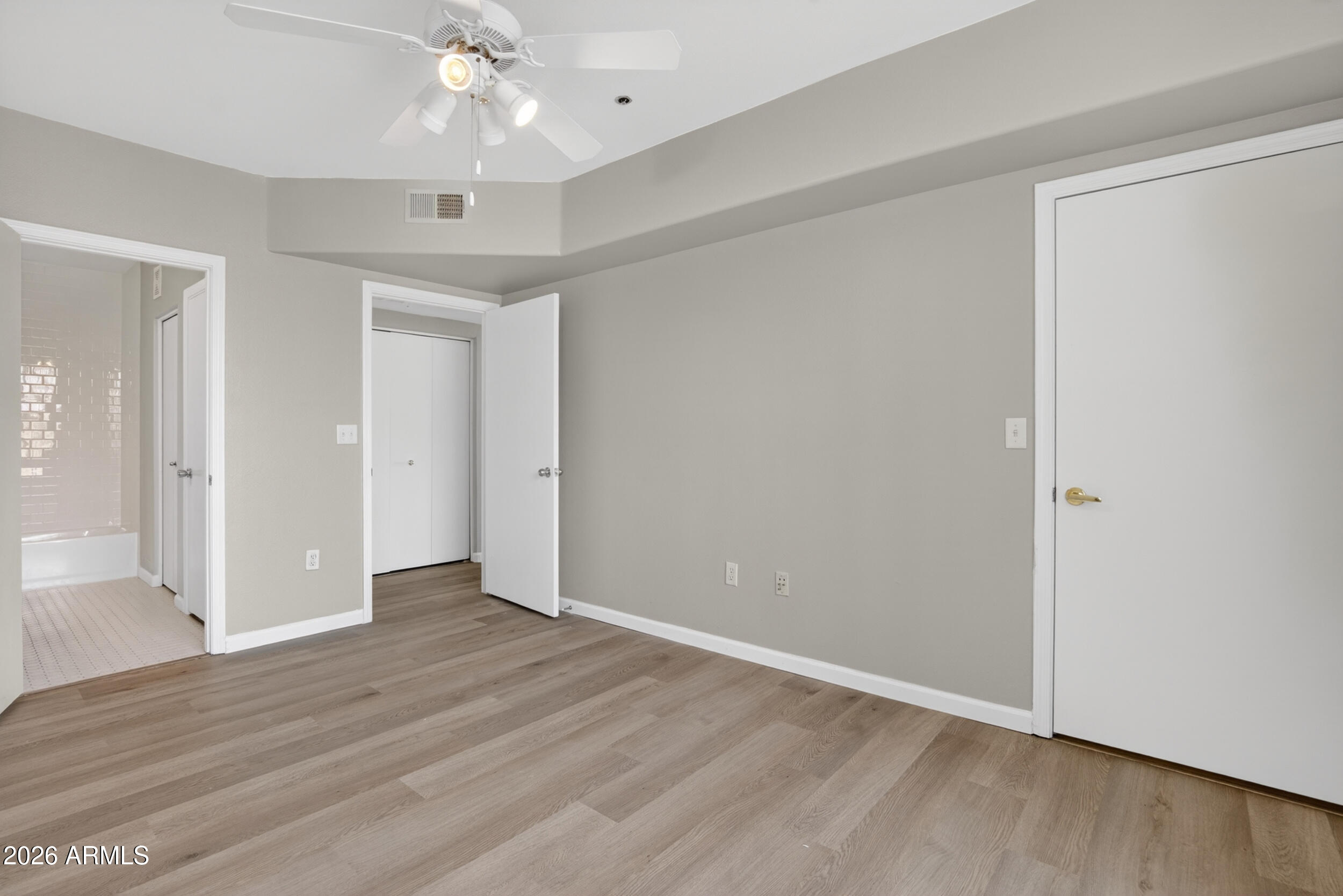 2134 East Broadway Road, Unit 1042 Tempe, AZ 85282 - Photo 25 of 33 a view of an empty room with wooden floor
