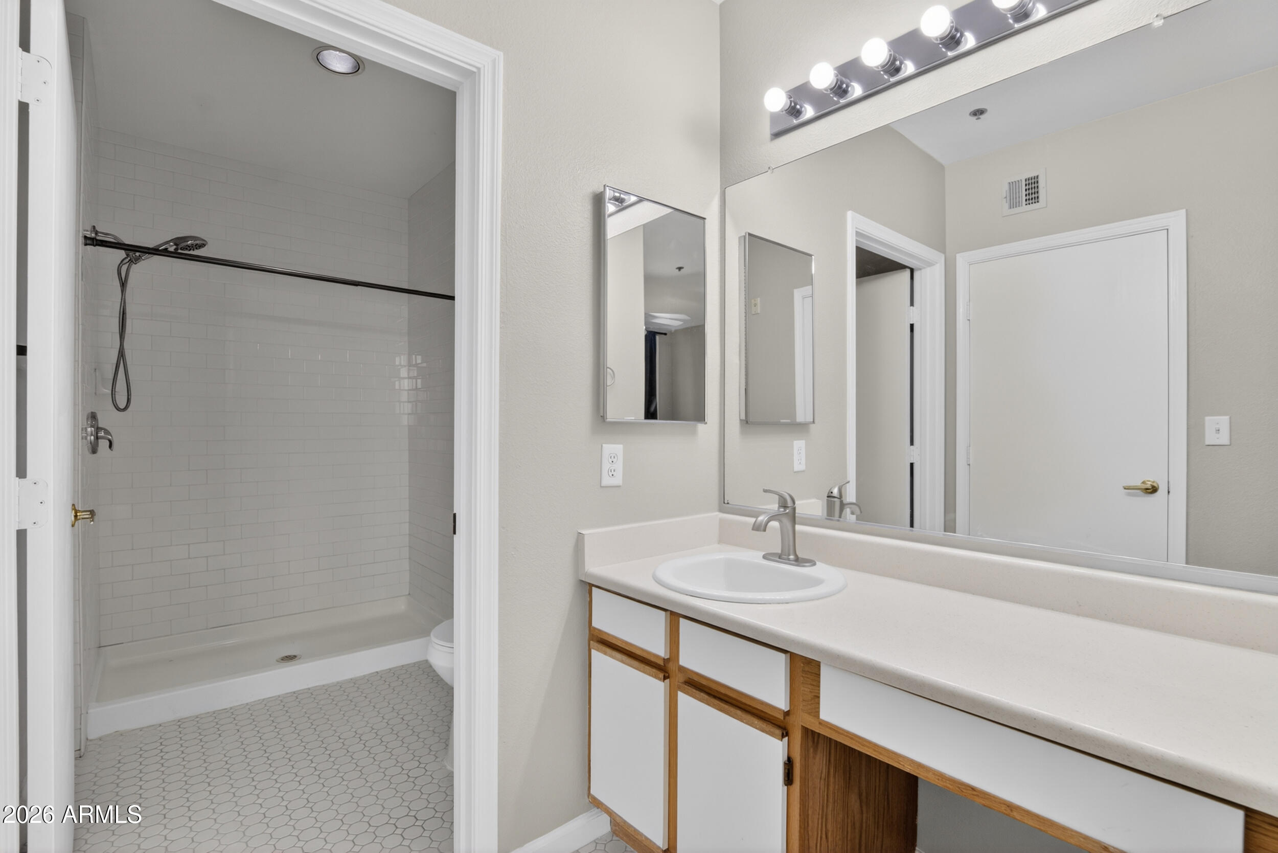 2134 East Broadway Road, Unit 1042 Tempe, AZ 85282 - Photo 27 of 33 a bathroom with a shower sink and mirror