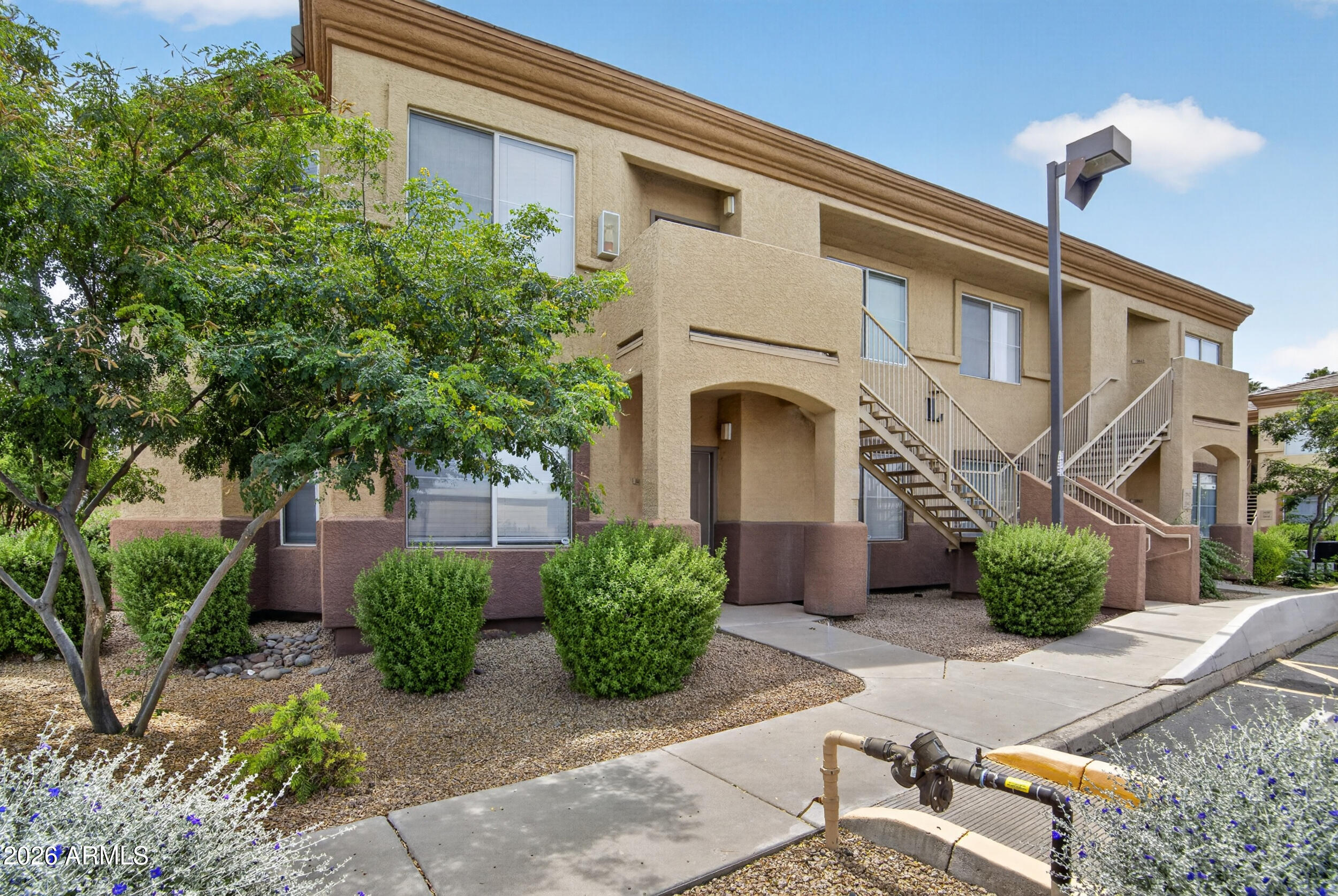 2134 East Broadway Road, Unit 1042 Tempe, AZ 85282 - Photo 31 of 33 a front view of a house with garden