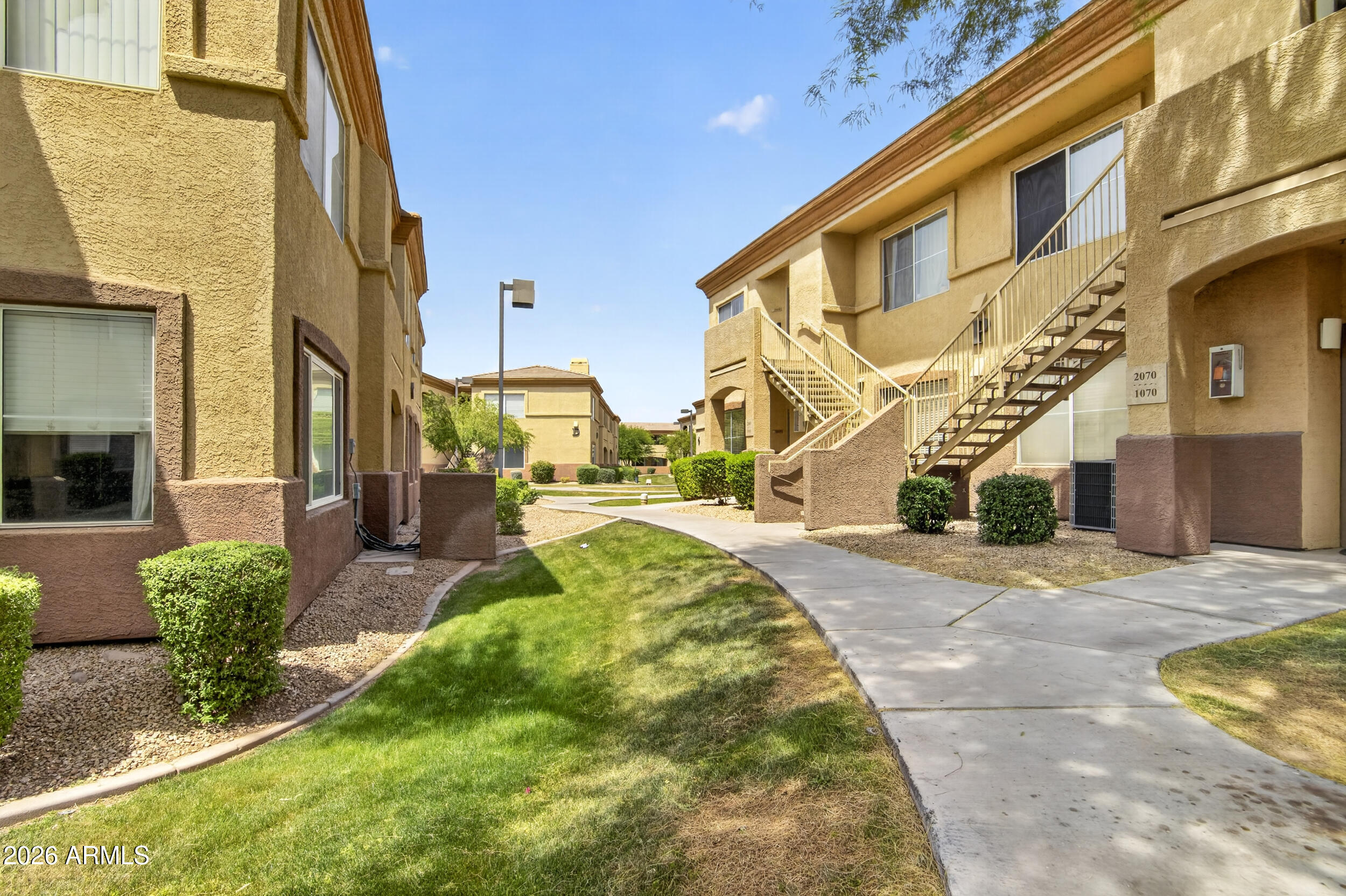 2134 East Broadway Road, Unit 1042 Tempe, AZ 85282 - Photo 32 of 33 a view of a building with a yard