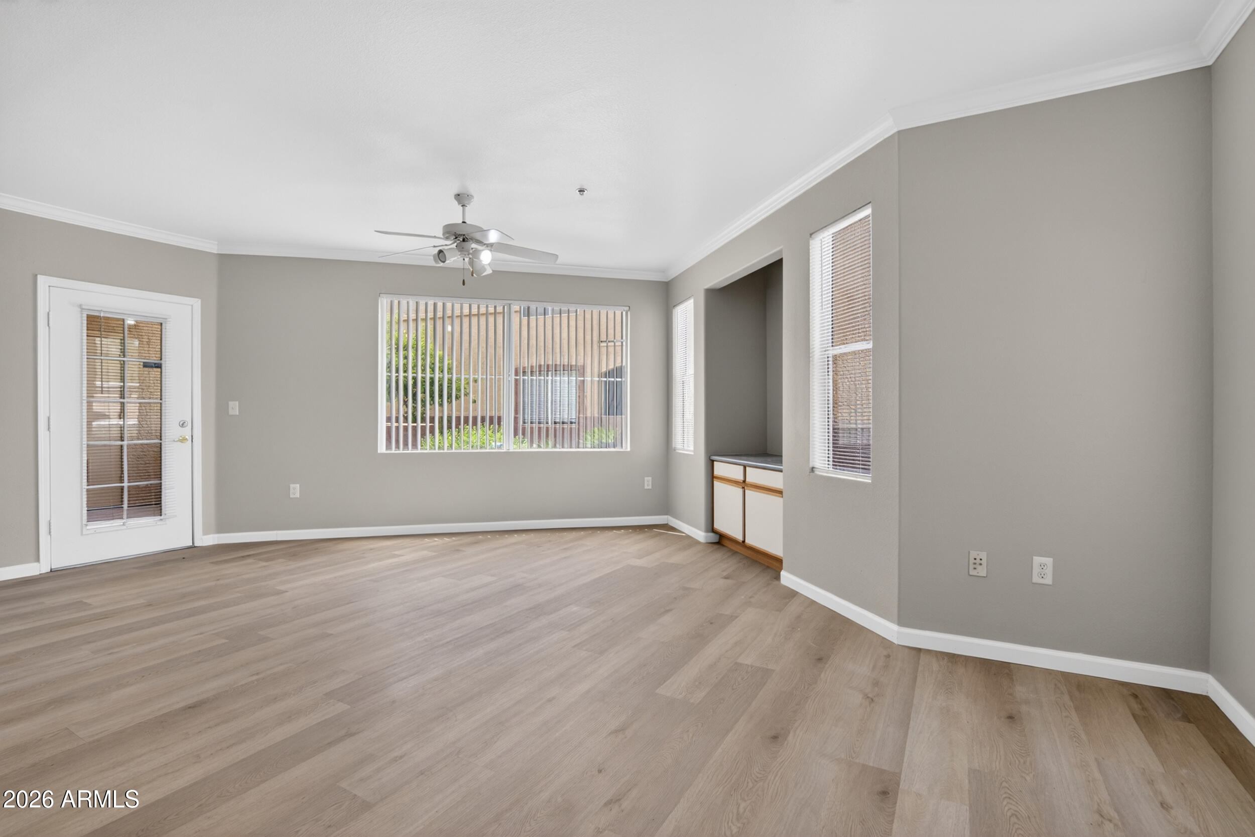 2134 East Broadway Road, Unit 1042 Tempe, AZ 85282 - Photo 5 of 33 wooden floor in an empty room with a window