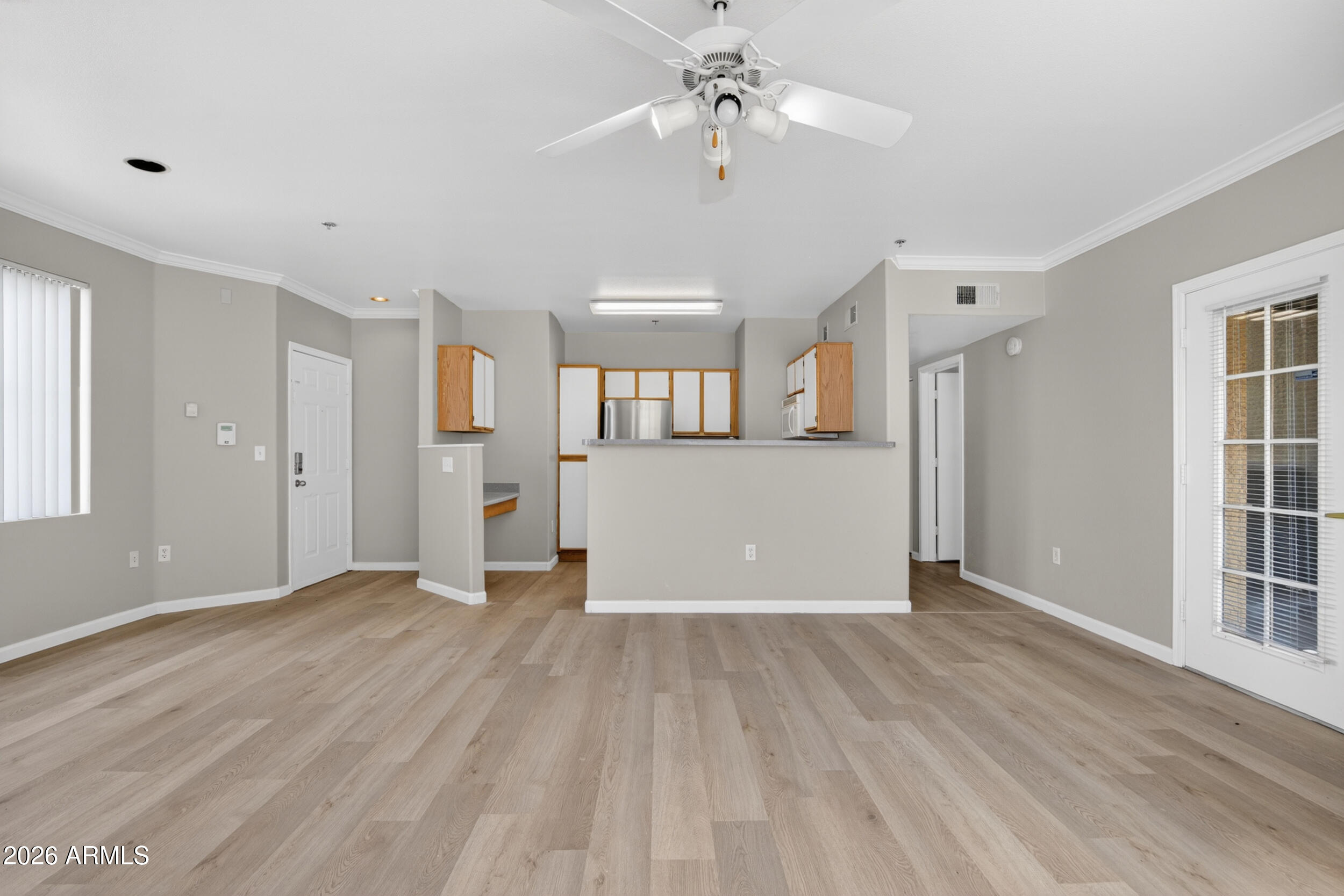 2134 East Broadway Road, Unit 1042 Tempe, AZ 85282 - Photo 7 of 33 a view of a big room with wooden floor and windows