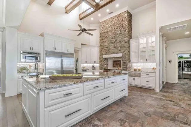 a kitchen with granite countertop a stove and stainless steel appliances