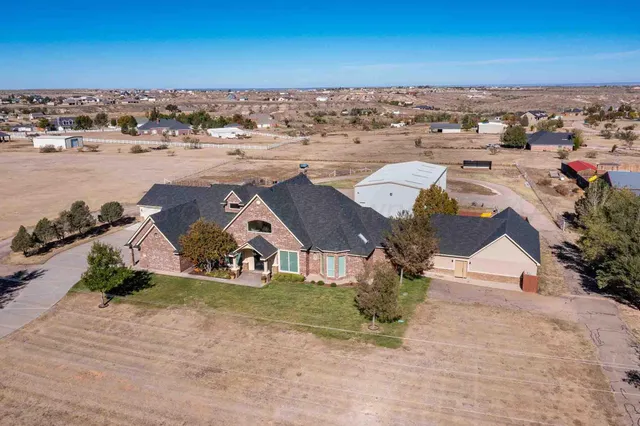 a house with huge green field in front of it
