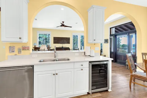 a bathroom with a granite countertop sink a mirror and a shower