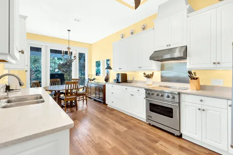 a view of a patio with table and chairs with wooden floor and fence