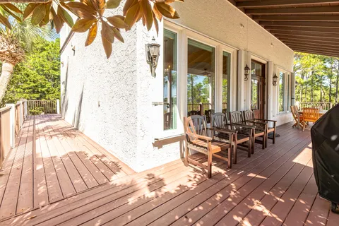 a living room with furniture large window and wooden floor