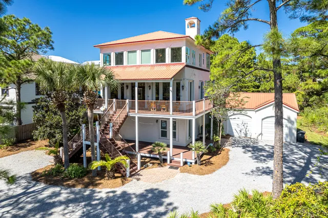 an aerial view of a house with balcony and outdoor seating