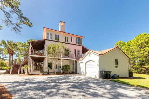 a living room with furniture a table and a large window