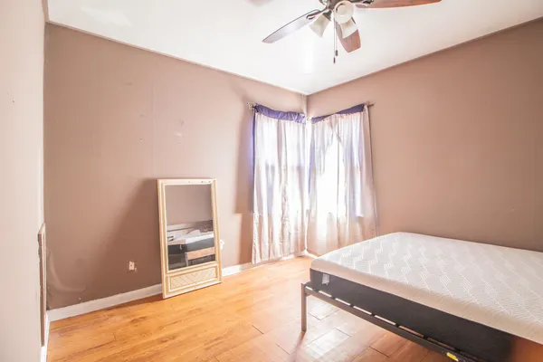 an empty room with windows and closet