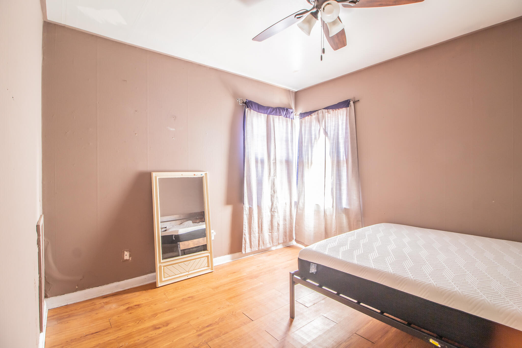3215 Itasca Street Lubbock, TX 79415 - Photo 11 of 20 a bedroom with a bed and a chandelier