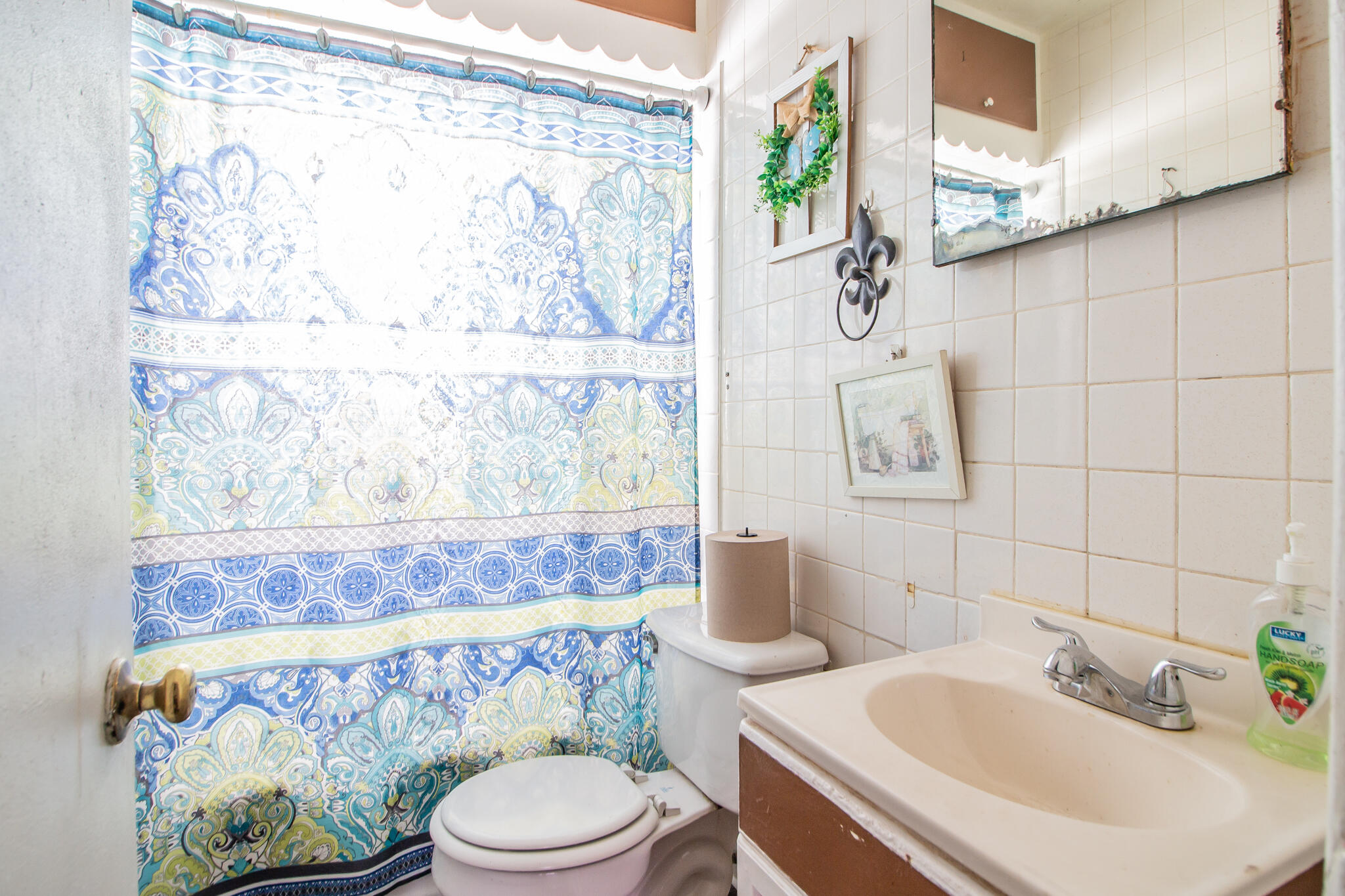 3215 Itasca Street Lubbock, TX 79415 - Photo 14 of 20 a bathroom with a sink mirror vanity and toilet