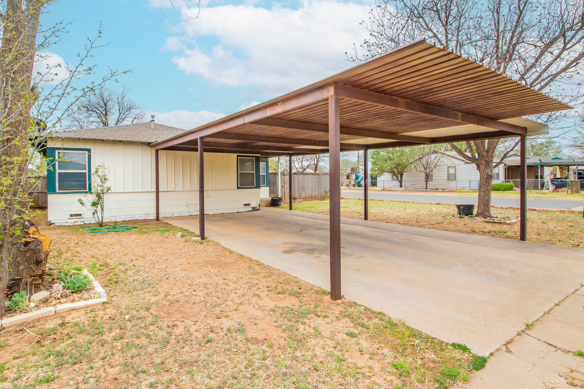 3215 Itasca Street Lubbock, TX 79415 - Photo 3 of 20 a patio with a table and chairs under an umbrella