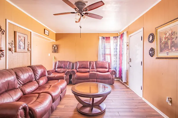 a living room with furniture a ceiling fan and a rug