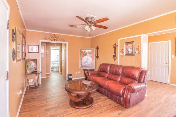 a living room with furniture and a chandelier