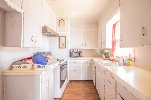 a utility room with cabinets washer and dryer