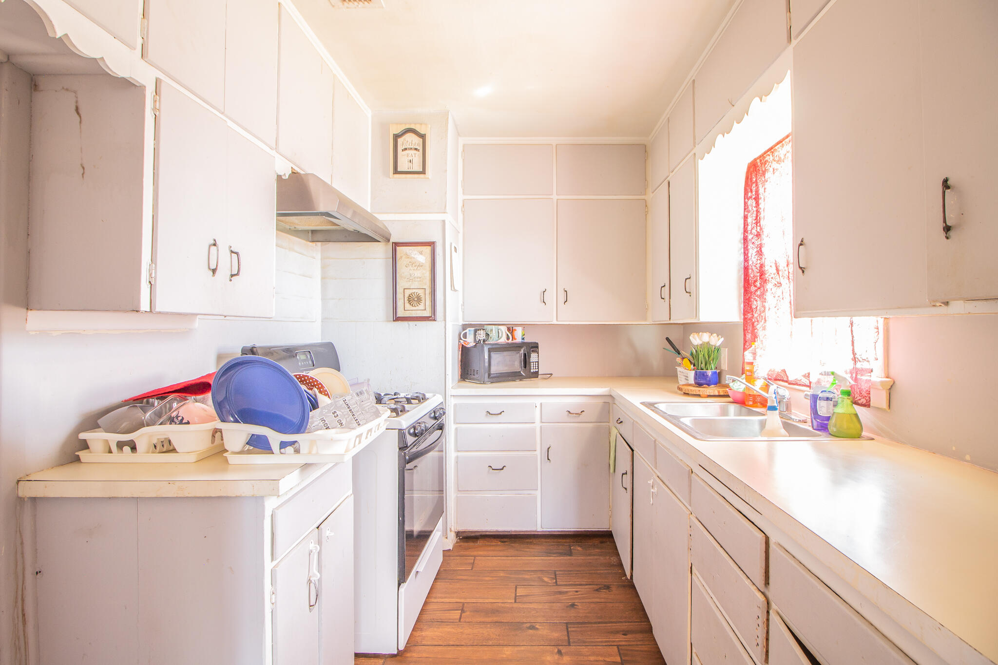 3215 Itasca Street Lubbock, TX 79415 - Photo 8 of 20 a kitchen with a sink a stove and cabinets